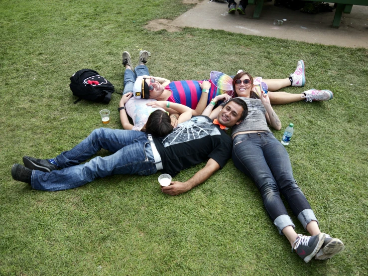 group of people lounging on green grass