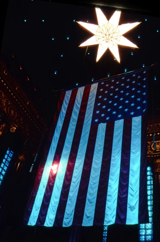 a big american flag is being displayed in the dark