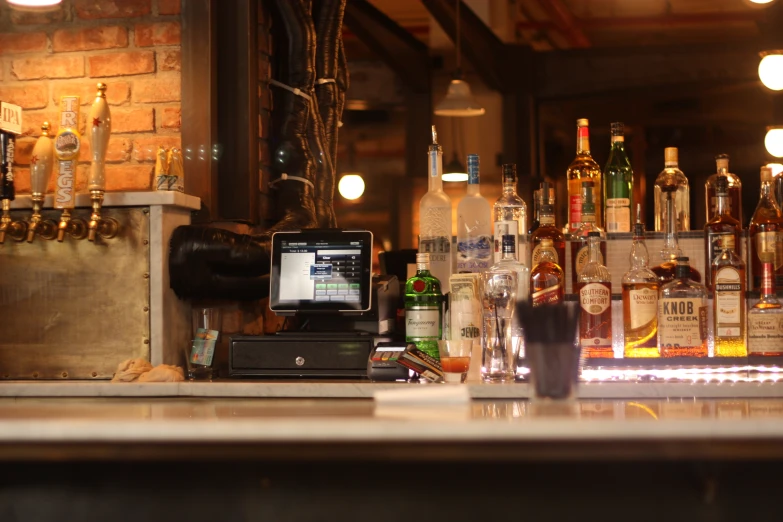 a counter top with bottles and a computer