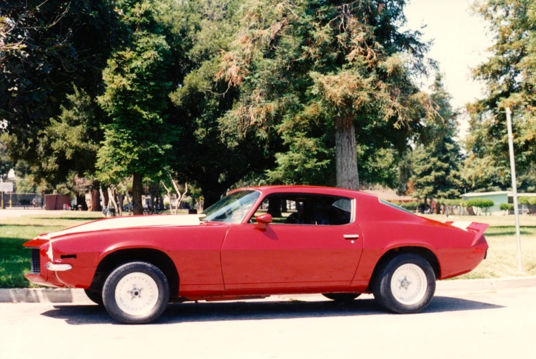 the red sports car is parked on the side of the street