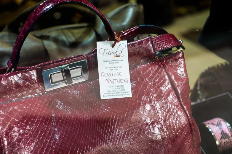 an open purple bag on display with a price tag on it