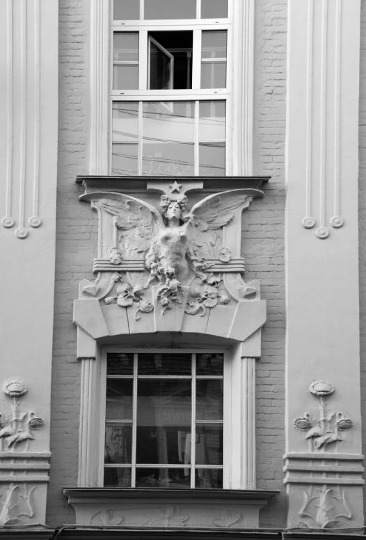 an ornate balcony on a grey brick building