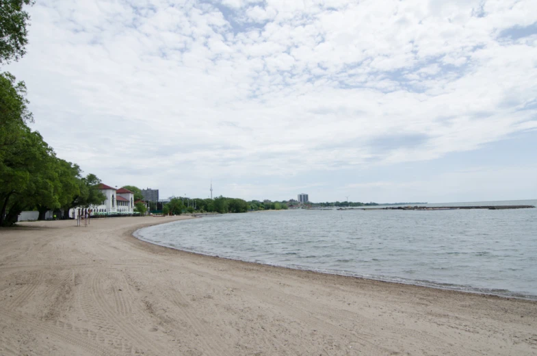 a beach near the ocean with a lot of water and buildings