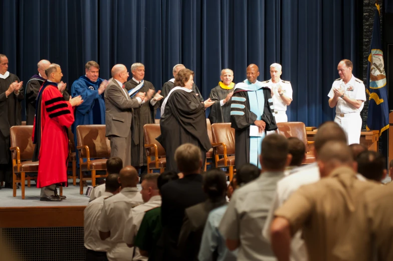 a group of men standing on top of a stage