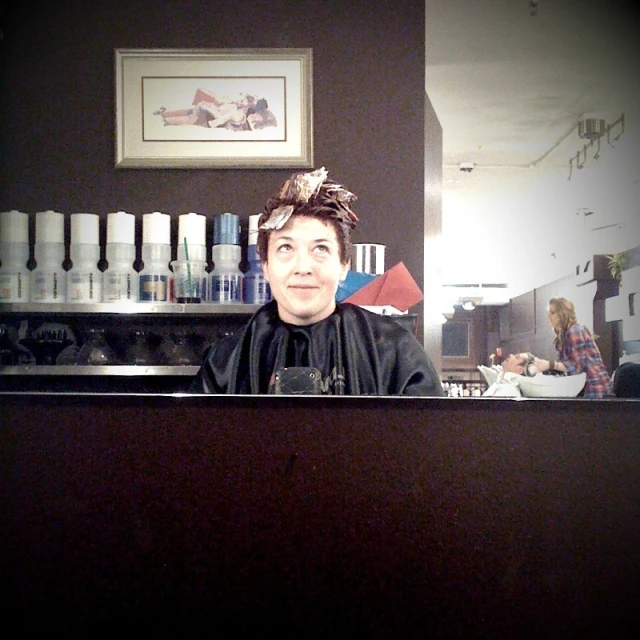 a man in a black shirt sitting at a counter