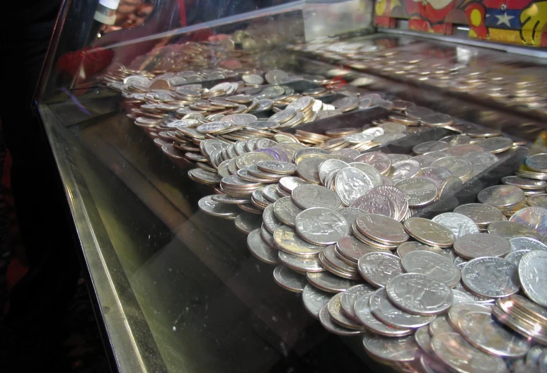 a bunch of coins on a display stand at a store