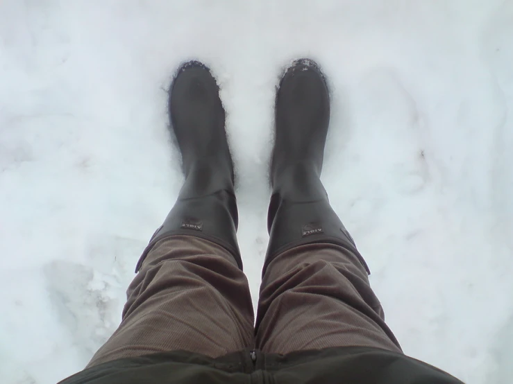 a person's feet covered in water as it snows