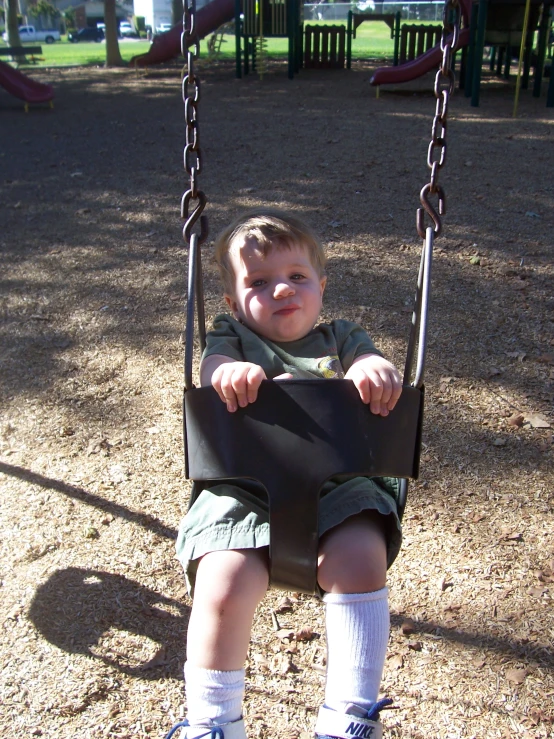 a young child is enjoying some time on the swing