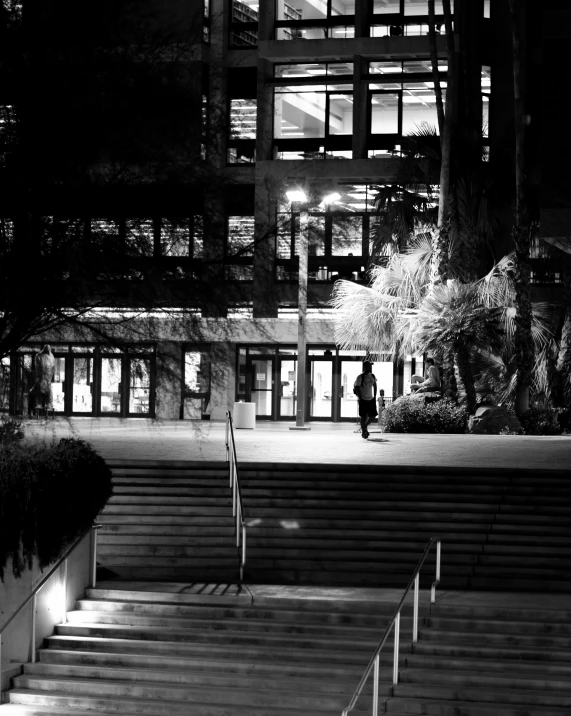 a dark and lonely building lit up with street lights