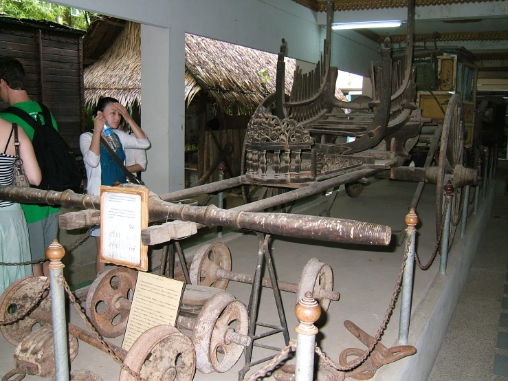 people look at large wooden ships for sale