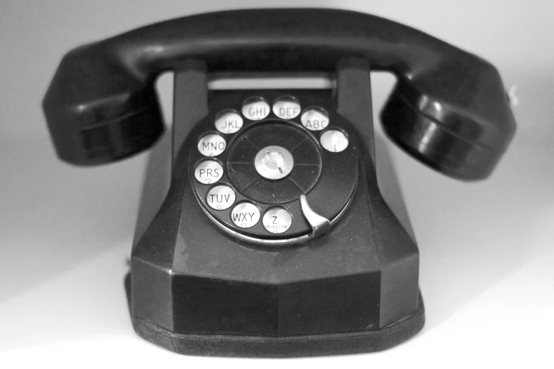 old fashioned telephone in black and white with four dials