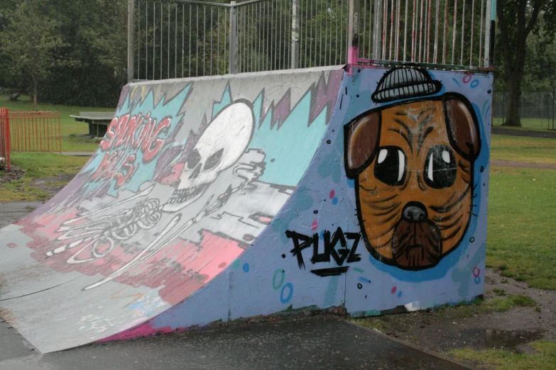 two colorful ramp boards covered in graffiti on them