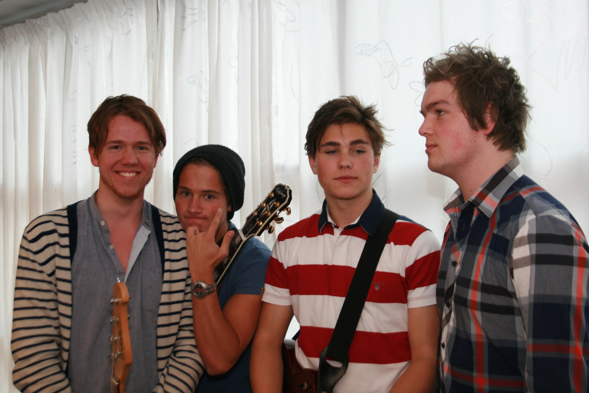 there are four young people posing for the camera