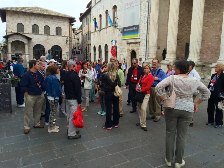 crowd of people walking down city square during daytime