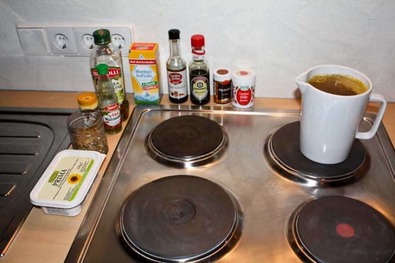 the top of the gas stove has been completely covered by various ingredients, including an egg washer