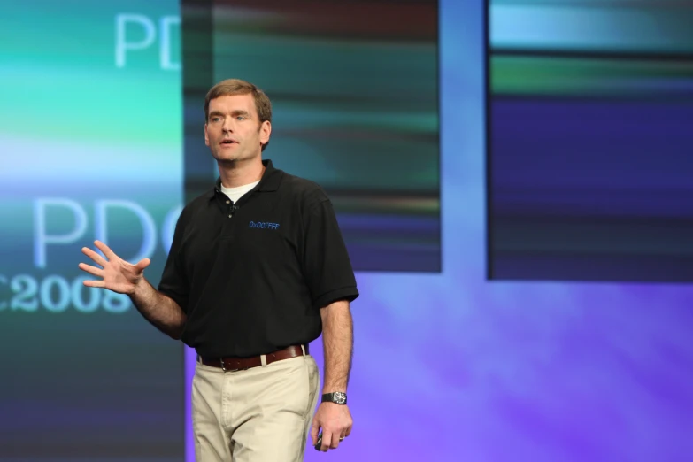 a man is giving a presentation at the conference