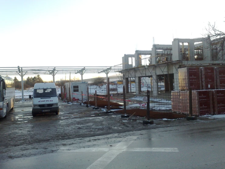 a large truck drives down a road next to the construction area