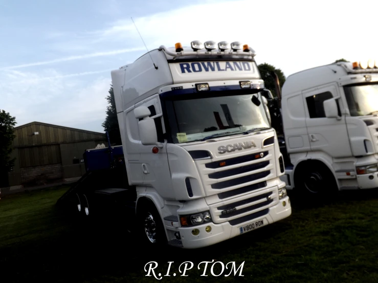 two large white trucks parked next to each other