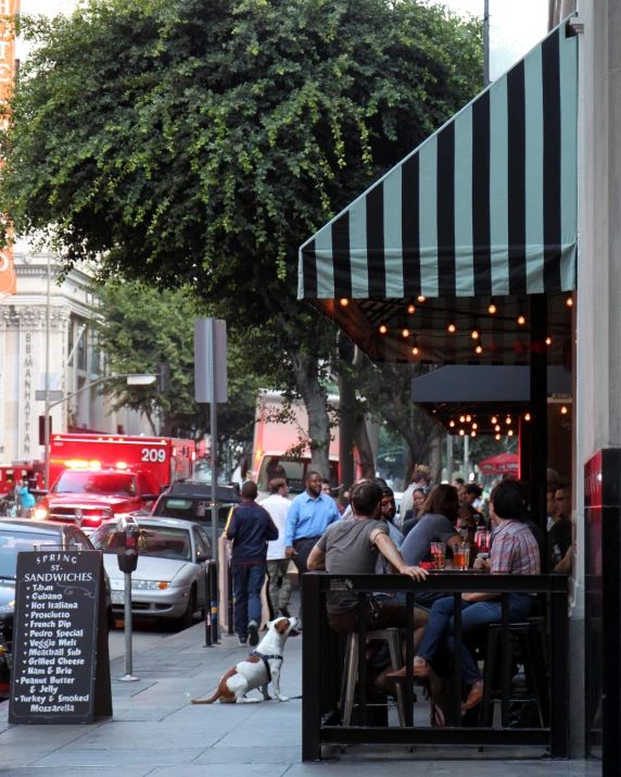 a restaurant with people sitting at tables outside