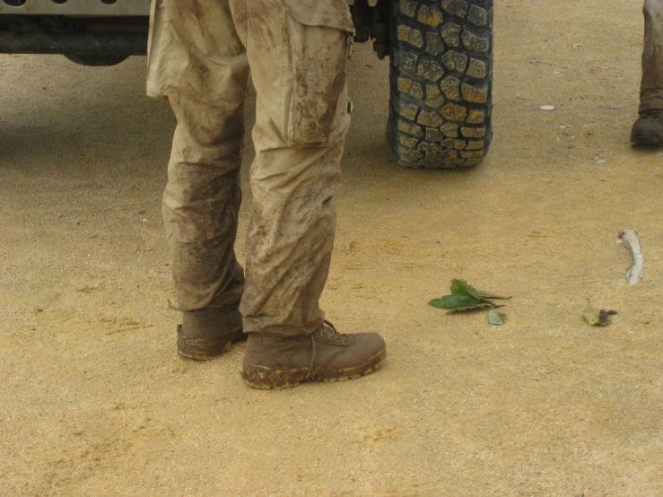 the man is standing next to the large truck