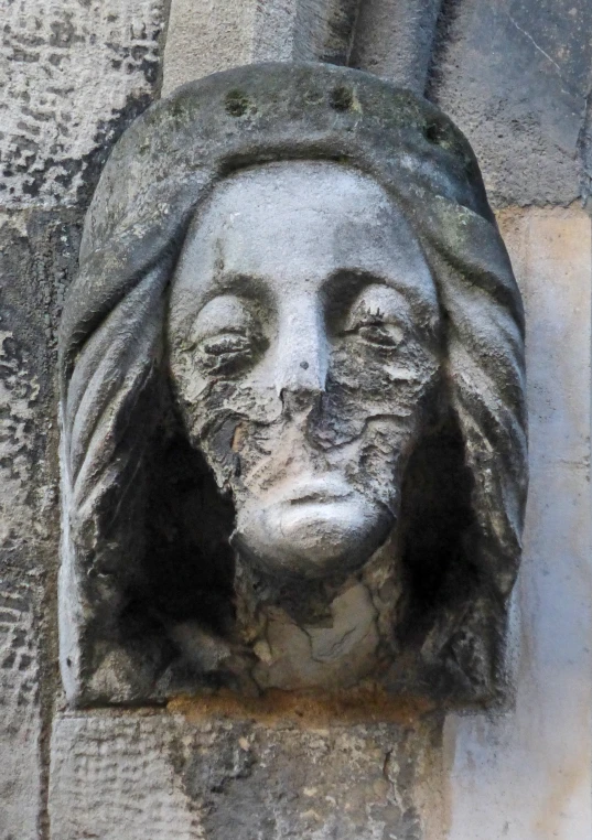 an old face with a long flowing hair on the wall