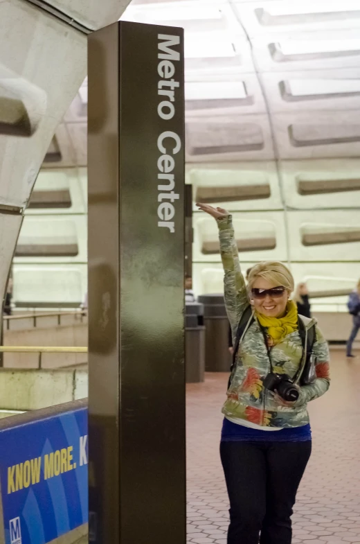 a woman is standing next to the signs