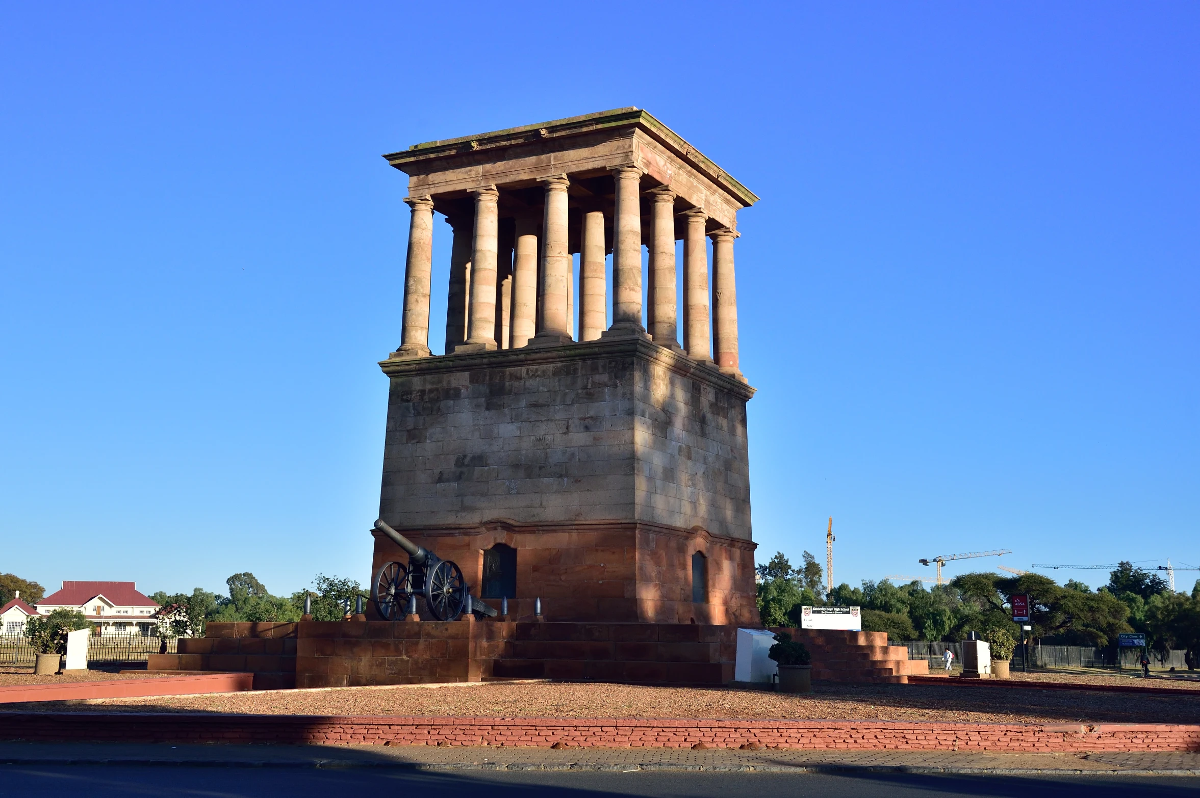 a tall tower with several columns in front