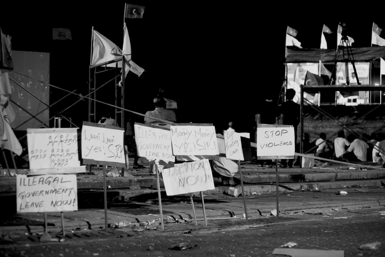 some signs in front of a large group of people