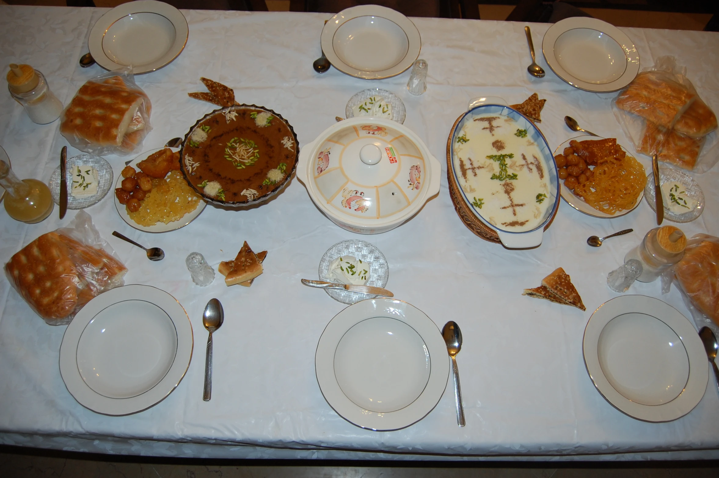 table set for a celetion with fancy plates and bread