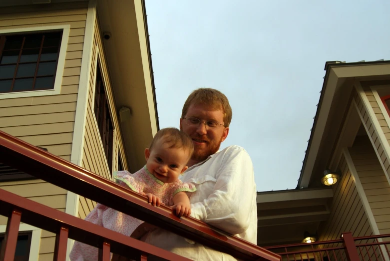 a man and  stand on an outside balcony