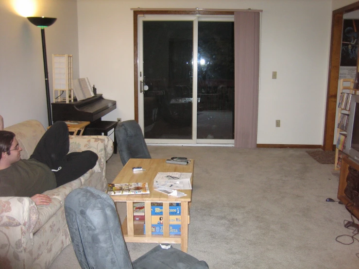 two men sitting on couches in a living room