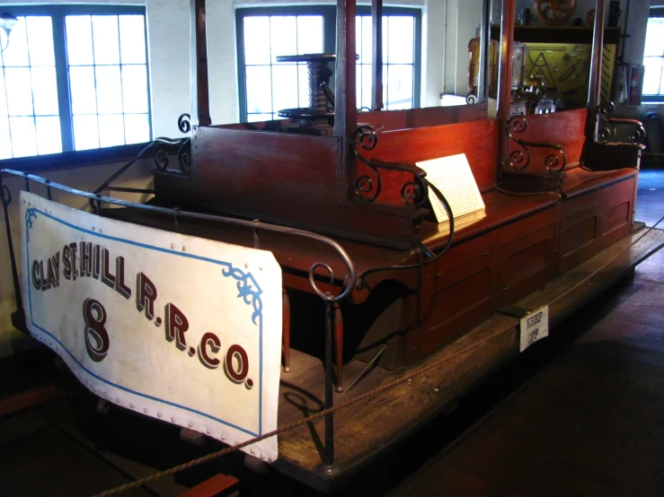 large wooden ship at an exhibit with other wooden structures