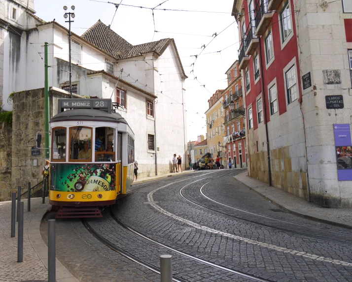 a trolley car with a painted design riding down the road