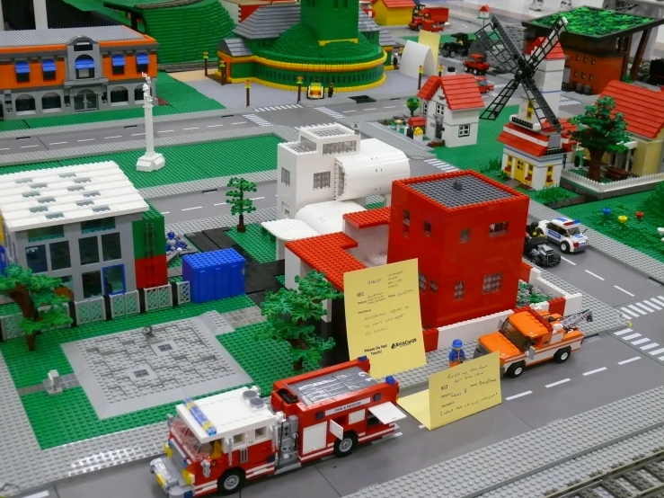 a model of a toy town with buildings, roads and cars
