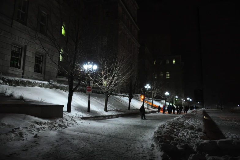 a city street covered in snow at night