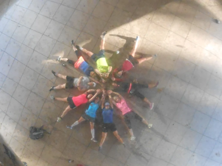 an aerial view of a group of people doing soing in the middle