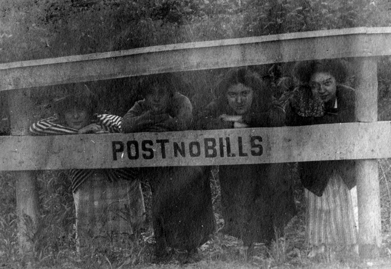 a group of people holding a post no bills sign