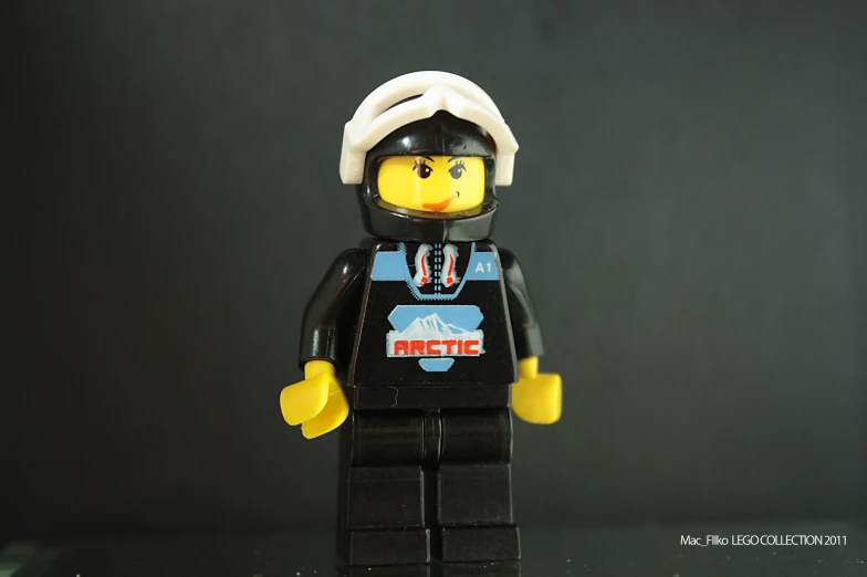 the small lego man is wearing a helmet and uniform