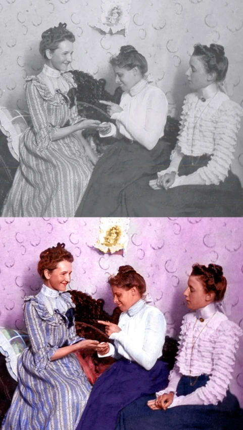 three ladies sit together, one reading a book and the other smiling