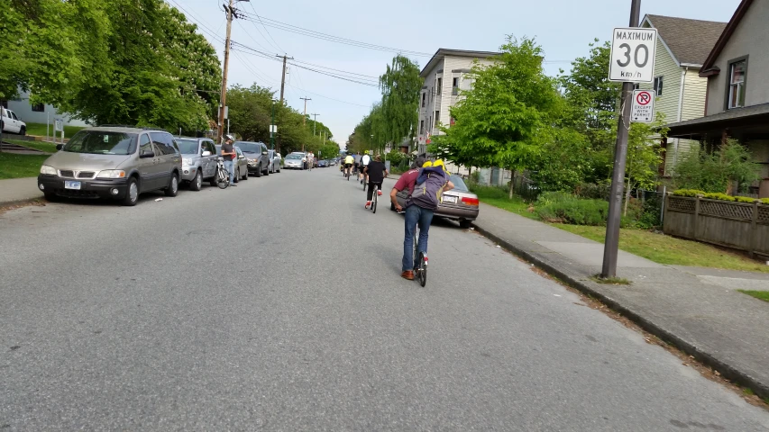 the people are riding their skateboards down the street