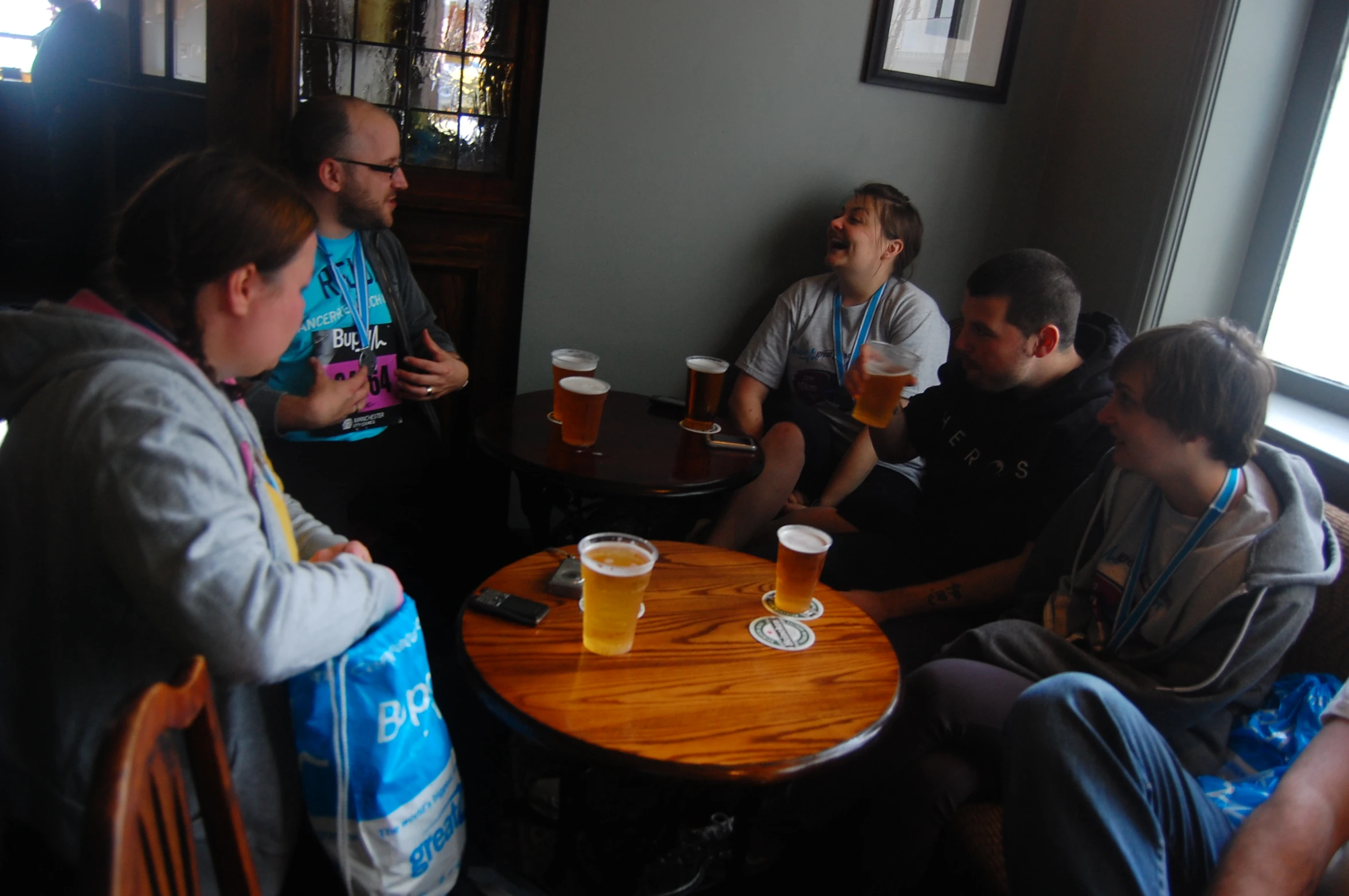 a group of men sitting at a wooden table next to each other