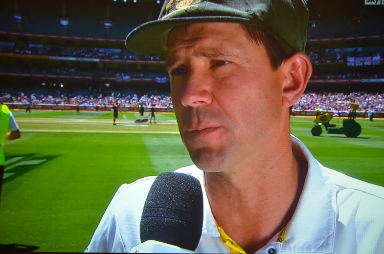 a close up of a person wearing a hat while on a television