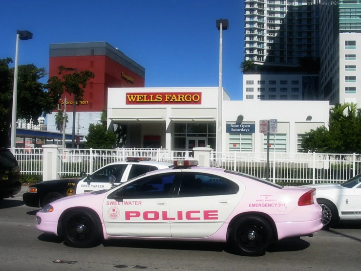 there is a police car that is pink with a pink on it