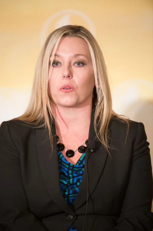 a woman with blond hair is sitting down