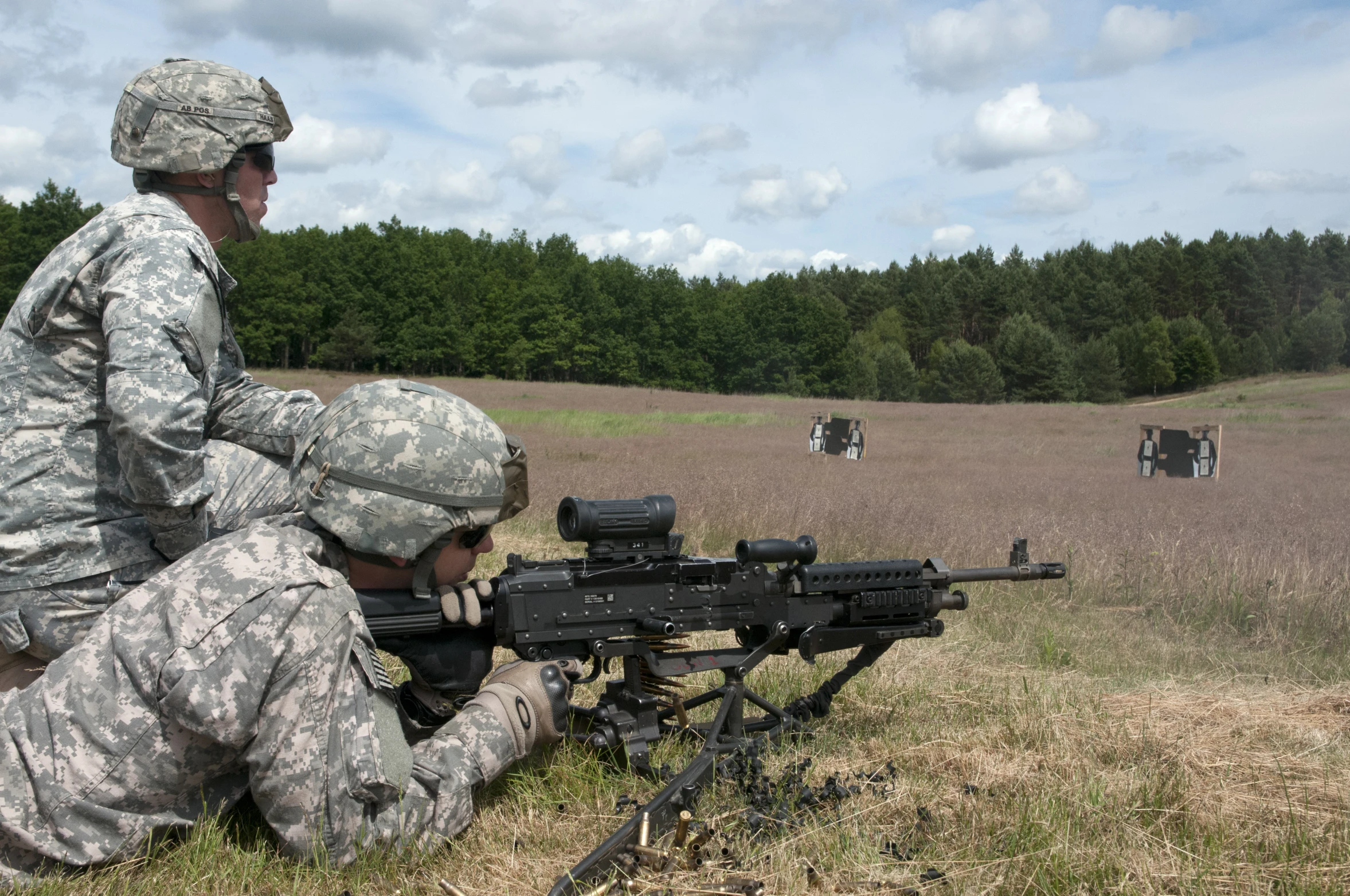 the man in uniform is holding up a machine that he has set