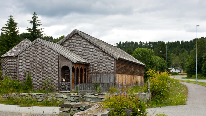 a small wooden building sits near a road