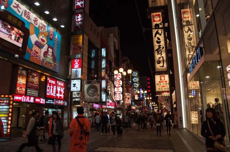 a crowded sidewalk with a woman walking in the center