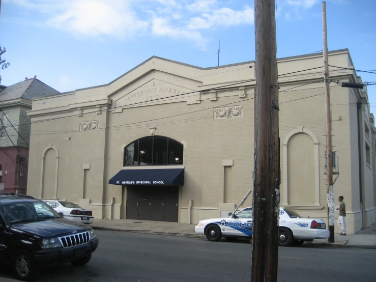 a police car is parked in front of a building