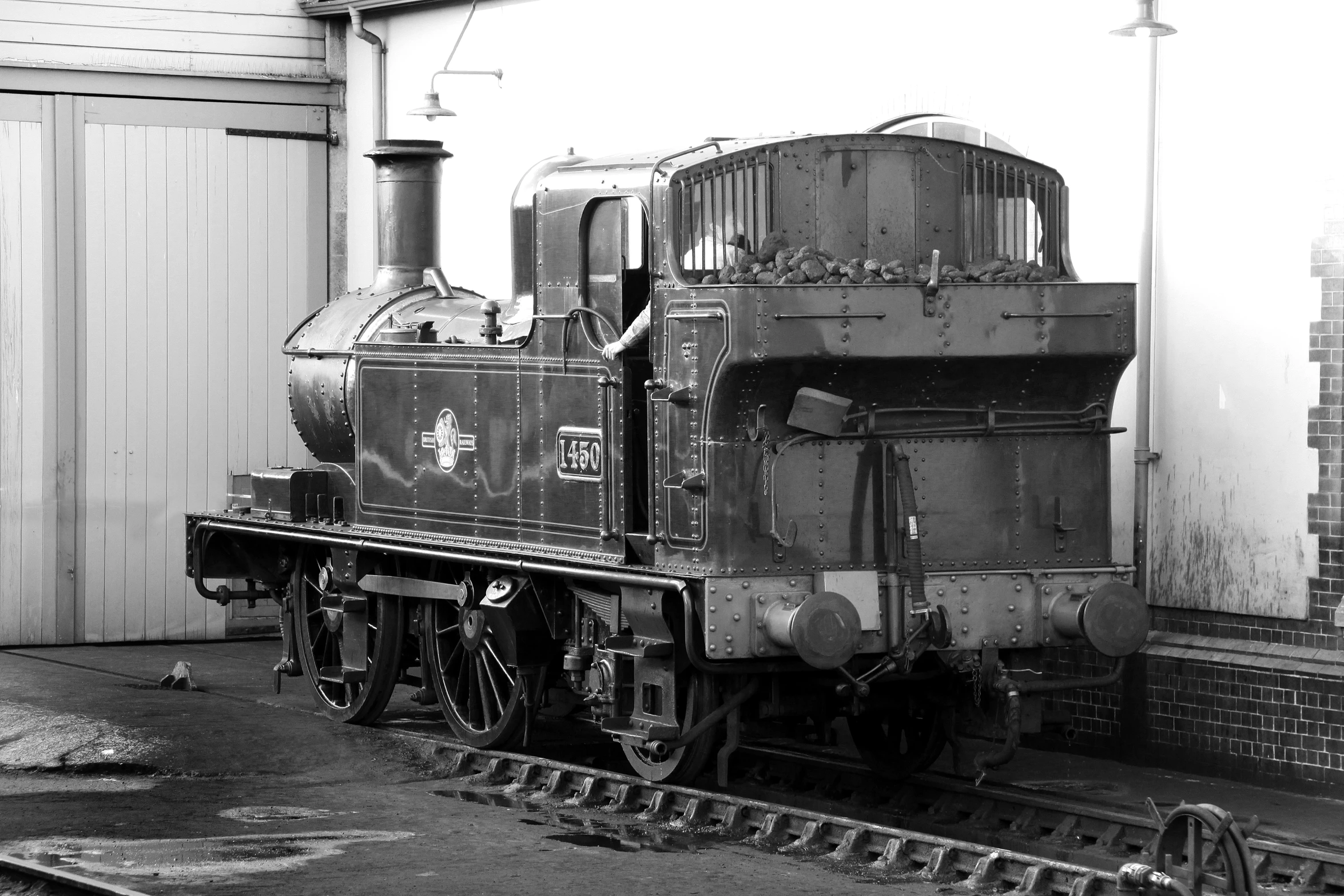 an old, black - and - white pograph of a train engine on tracks