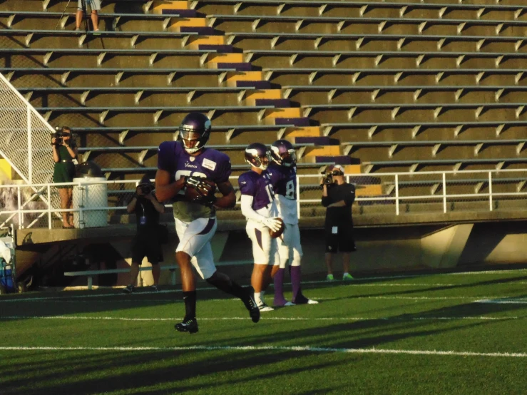 a football player runs after catching a ball